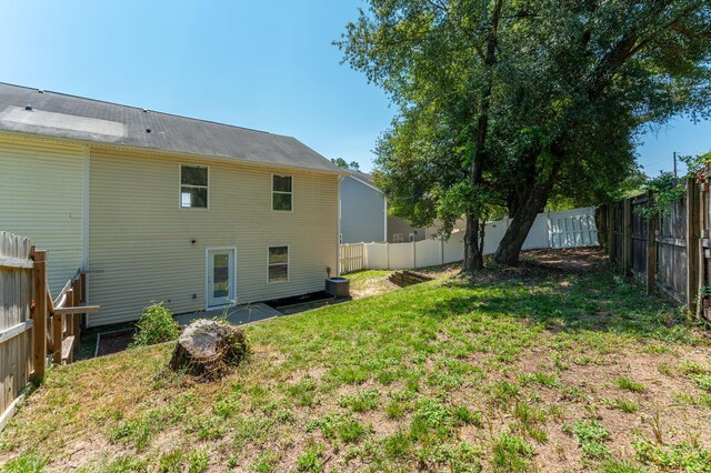 rear view of property with a lawn