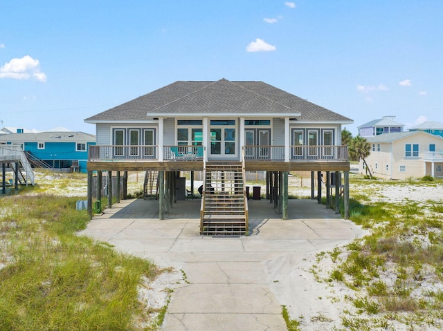 rear view of property featuring a carport and a sunroom