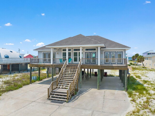 rear view of house with a carport and a porch