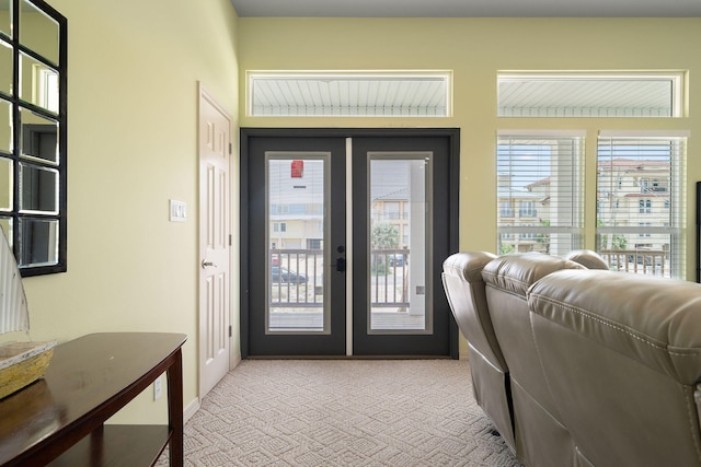 doorway to outside featuring light colored carpet and french doors