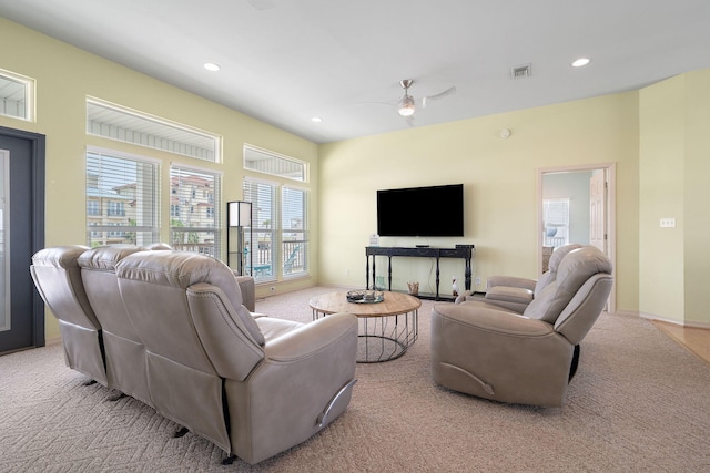 living room with light colored carpet and ceiling fan