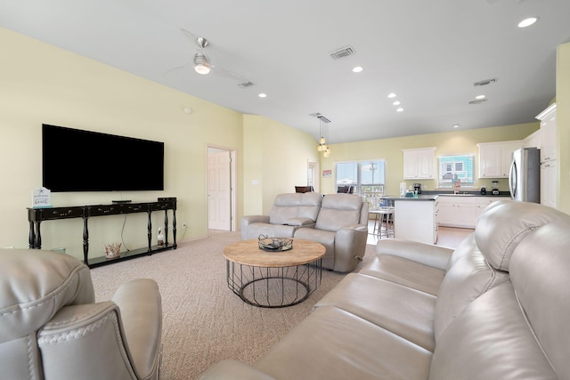 living room featuring sink and light carpet