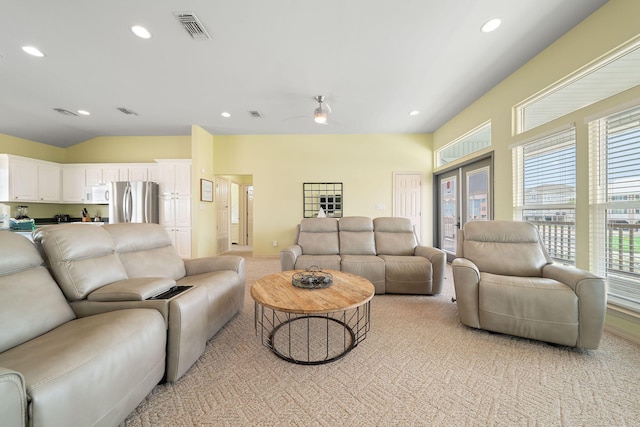 carpeted living room with vaulted ceiling and ceiling fan