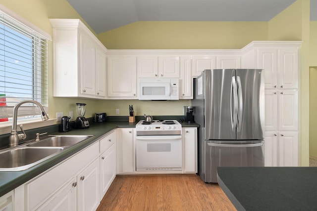 kitchen with sink, vaulted ceiling, light hardwood / wood-style flooring, white appliances, and white cabinets