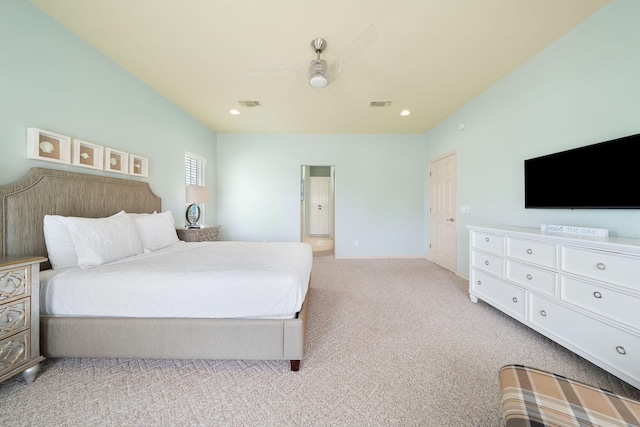 bedroom featuring light carpet, ensuite bath, and ceiling fan