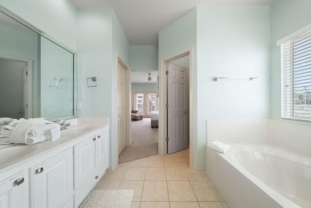 bathroom featuring vanity, a tub to relax in, and tile patterned floors