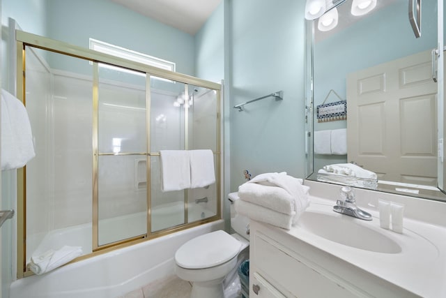 full bathroom with tile patterned flooring, enclosed tub / shower combo, vanity, and toilet