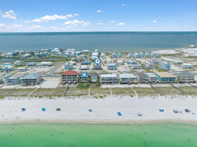 bird's eye view with a water view and a beach view