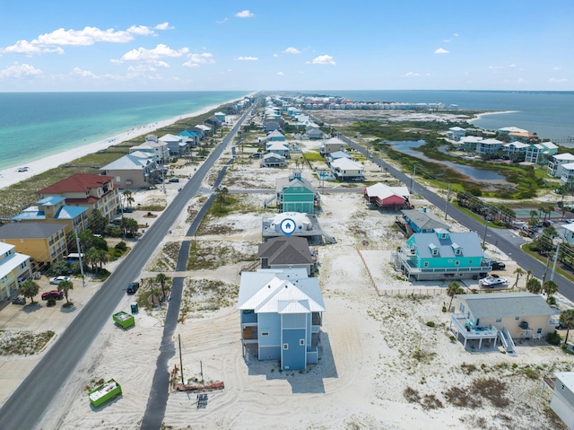 birds eye view of property featuring a beach view and a water view