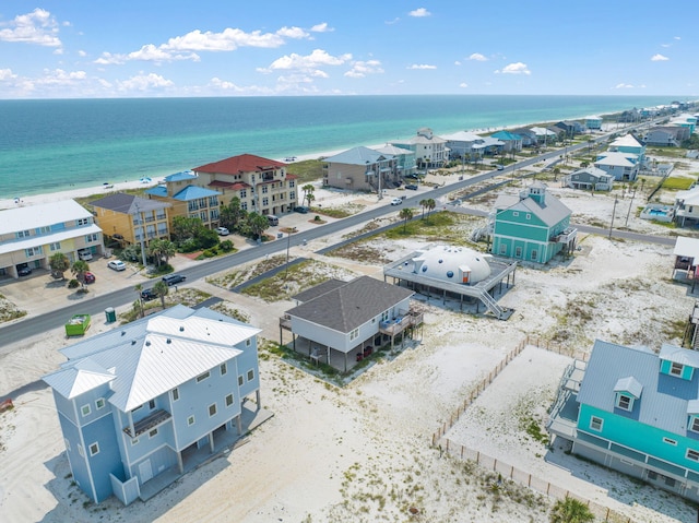 aerial view with a water view and a beach view