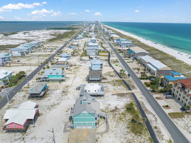 birds eye view of property featuring a beach view and a water view