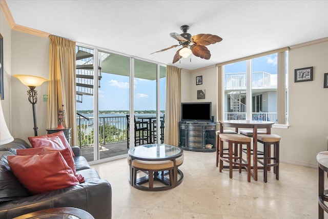 living area featuring crown molding, a wealth of natural light, floor to ceiling windows, and ceiling fan