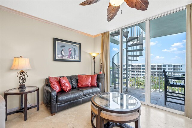 living room with baseboards, a ceiling fan, a view of city, a wall of windows, and crown molding