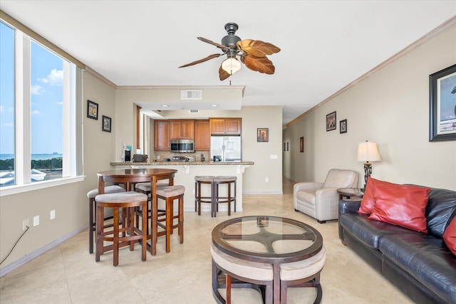 living area featuring ceiling fan, visible vents, baseboards, and crown molding