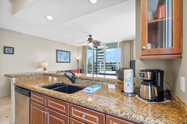 kitchen featuring dishwasher, light stone counters, brown cabinets, and a sink