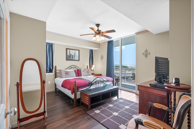 bedroom with dark wood-type flooring, a ceiling fan, baseboards, access to outside, and a wall of windows