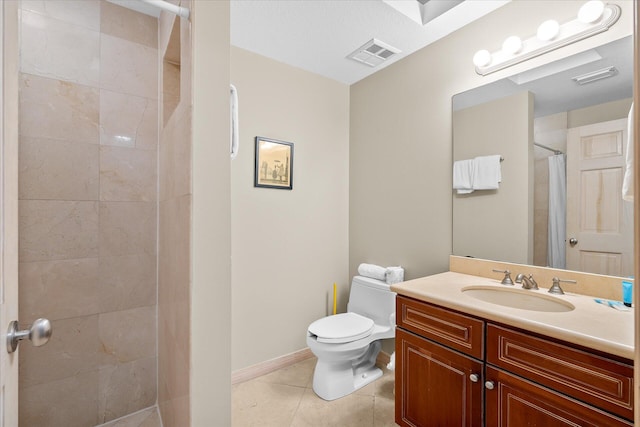 bathroom with visible vents, toilet, vanity, tile patterned flooring, and tiled shower