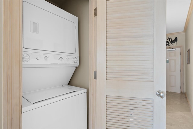 washroom with laundry area and stacked washer / drying machine