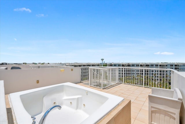 view of patio / terrace featuring a balcony and an outdoor hot tub