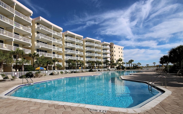 pool featuring a patio area and fence