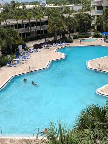 community pool with a community hot tub and a patio