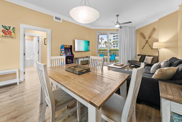 dining area with light hardwood / wood-style flooring, ceiling fan, and ornamental molding