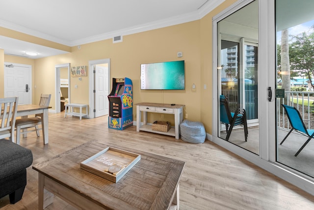 living room with hardwood / wood-style flooring and crown molding