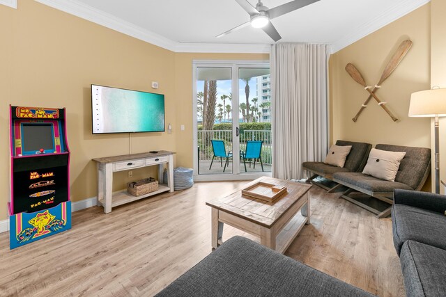 living room with light wood-type flooring, ornamental molding, and ceiling fan