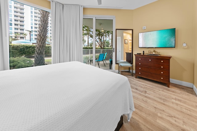 bedroom featuring light hardwood / wood-style flooring and access to exterior