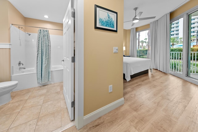 bathroom with ceiling fan, shower / bathtub combination with curtain, tile patterned flooring, and toilet