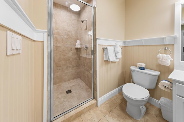 bathroom featuring tile patterned floors, toilet, vanity, and a shower with shower door