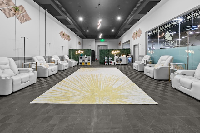 carpeted living room featuring a towering ceiling