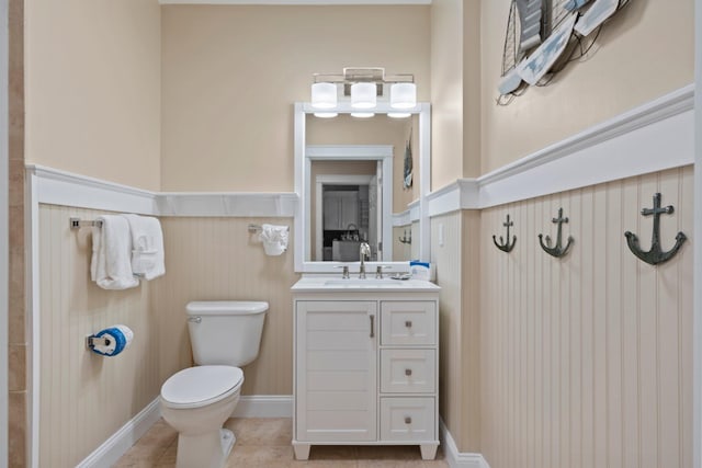 4203 Indian Bayou Trl Unit 1109, Destin, FL 32541 - bathroom with toilet, vanity, a wainscoted wall, and tile patterned flooring