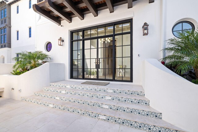 view of exterior entry featuring french doors