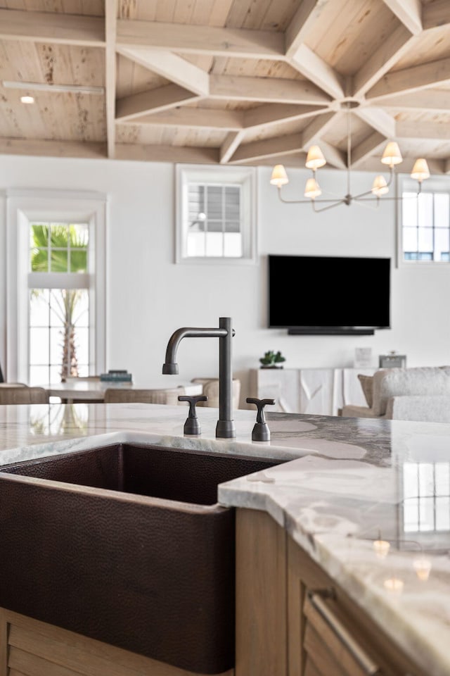 living room with sink, lofted ceiling with beams, wood ceiling, and a chandelier