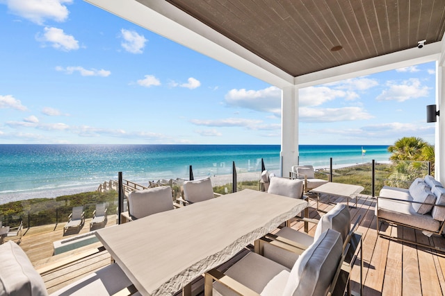 exterior space featuring a beach view, a water view, and an outdoor living space