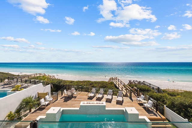 view of pool with a water view and a view of the beach