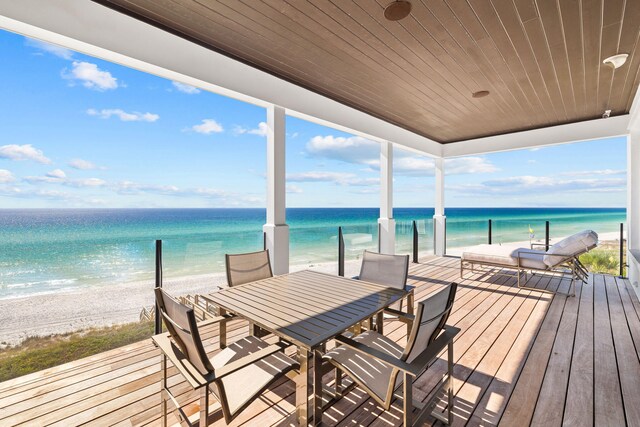 deck with a water view and a beach view