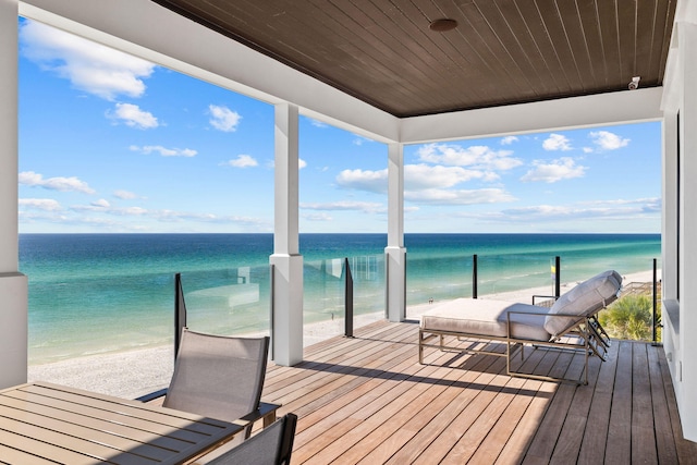 dock area with a water view and a balcony