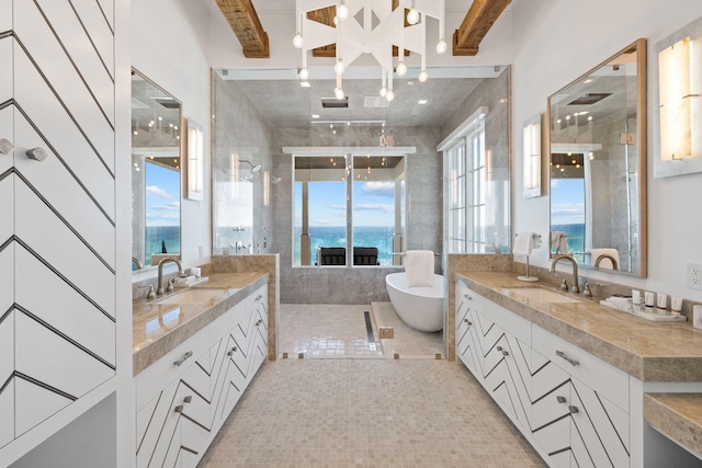 bathroom featuring beam ceiling, a water view, vanity, and tile patterned flooring