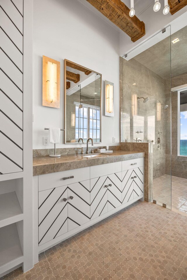 bathroom featuring beamed ceiling, vanity, a shower with door, and tile patterned flooring