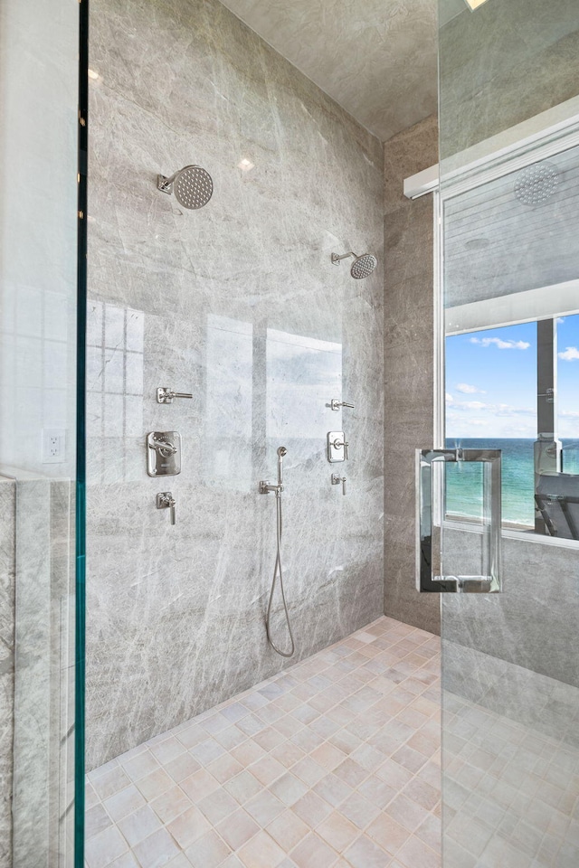 bathroom with a water view and a tile shower