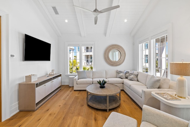 living room featuring vaulted ceiling with beams, ceiling fan, and light hardwood / wood-style floors