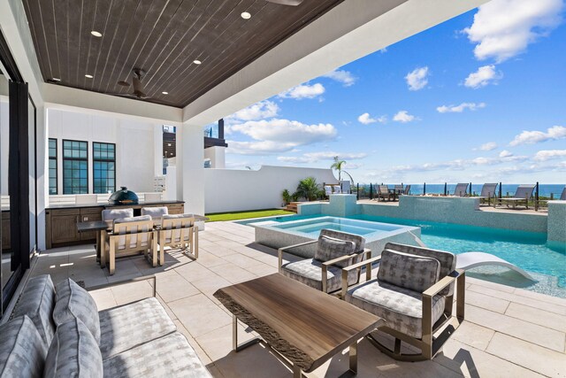 view of patio / terrace with a hot tub