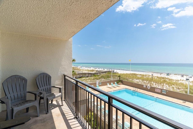 balcony with a community pool and a water view