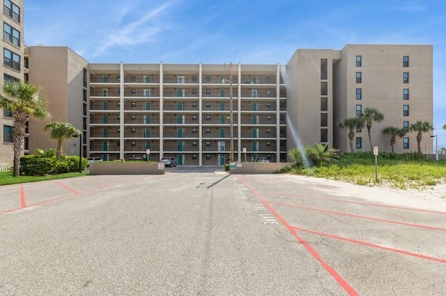 view of building exterior featuring uncovered parking