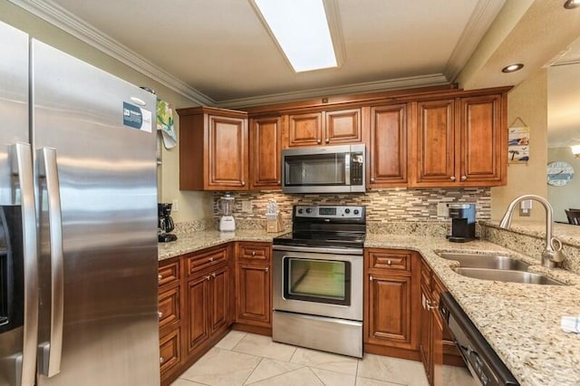 kitchen featuring a sink, stainless steel appliances, crown molding, and decorative backsplash