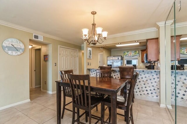 dining area featuring light tile patterned flooring, crown molding, baseboards, visible vents, and an inviting chandelier