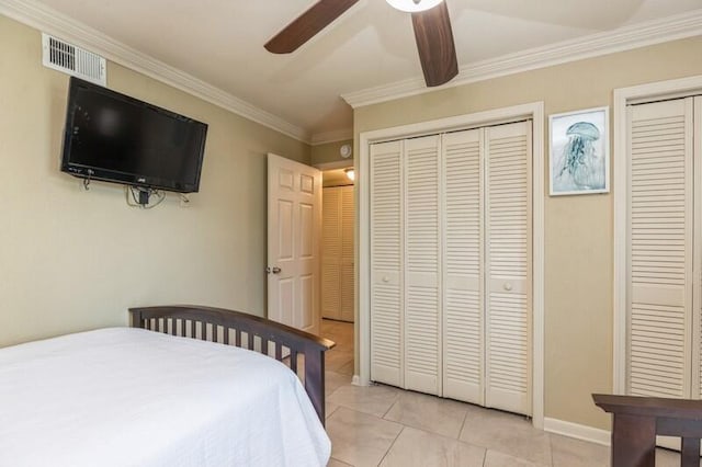 bedroom featuring light tile patterned flooring, crown molding, ceiling fan, and visible vents