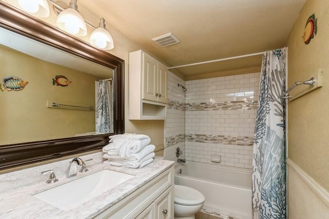 bathroom featuring visible vents, toilet, shower / tub combo, and vanity